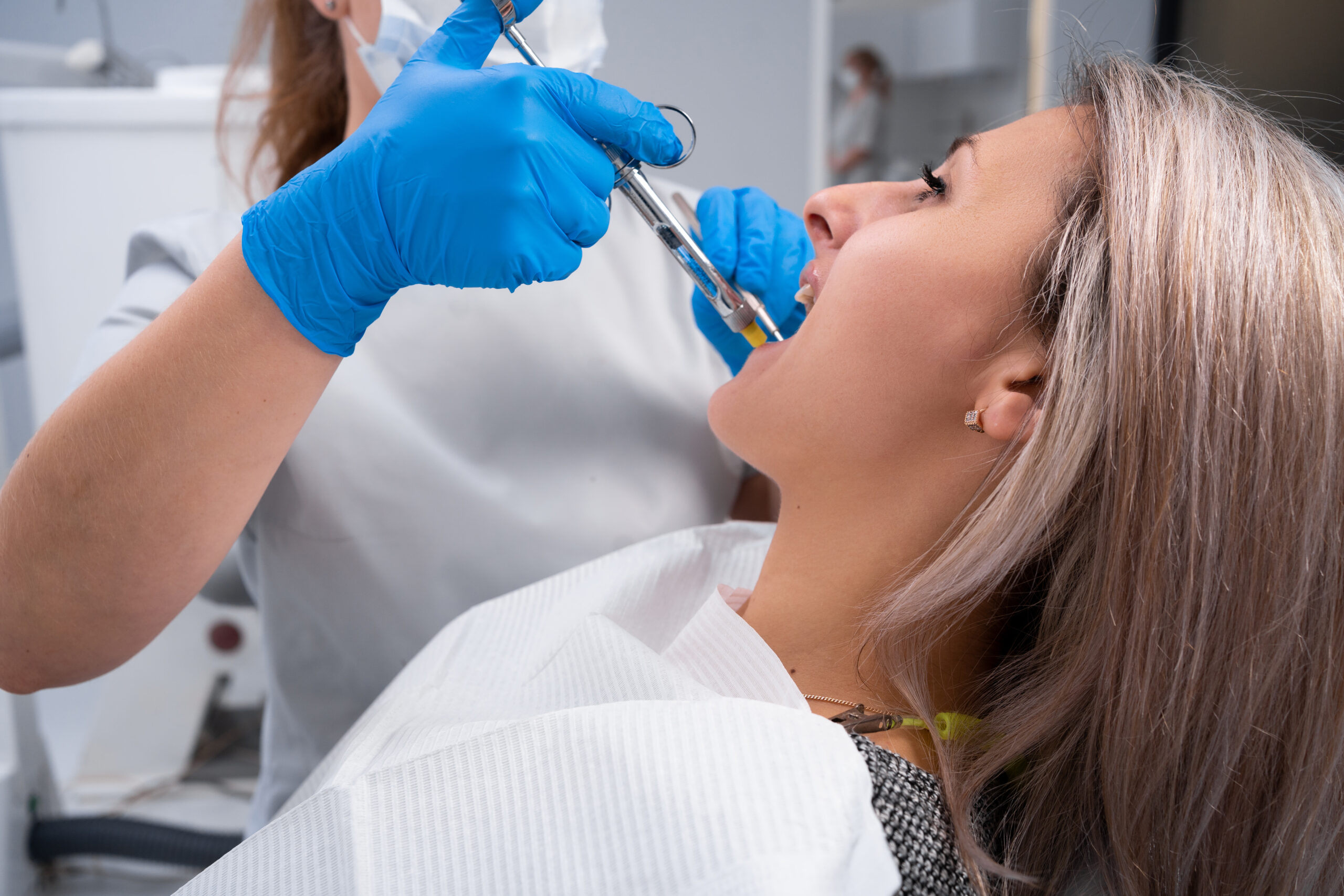 A woman receiving dental treatment with mandibular blocks.