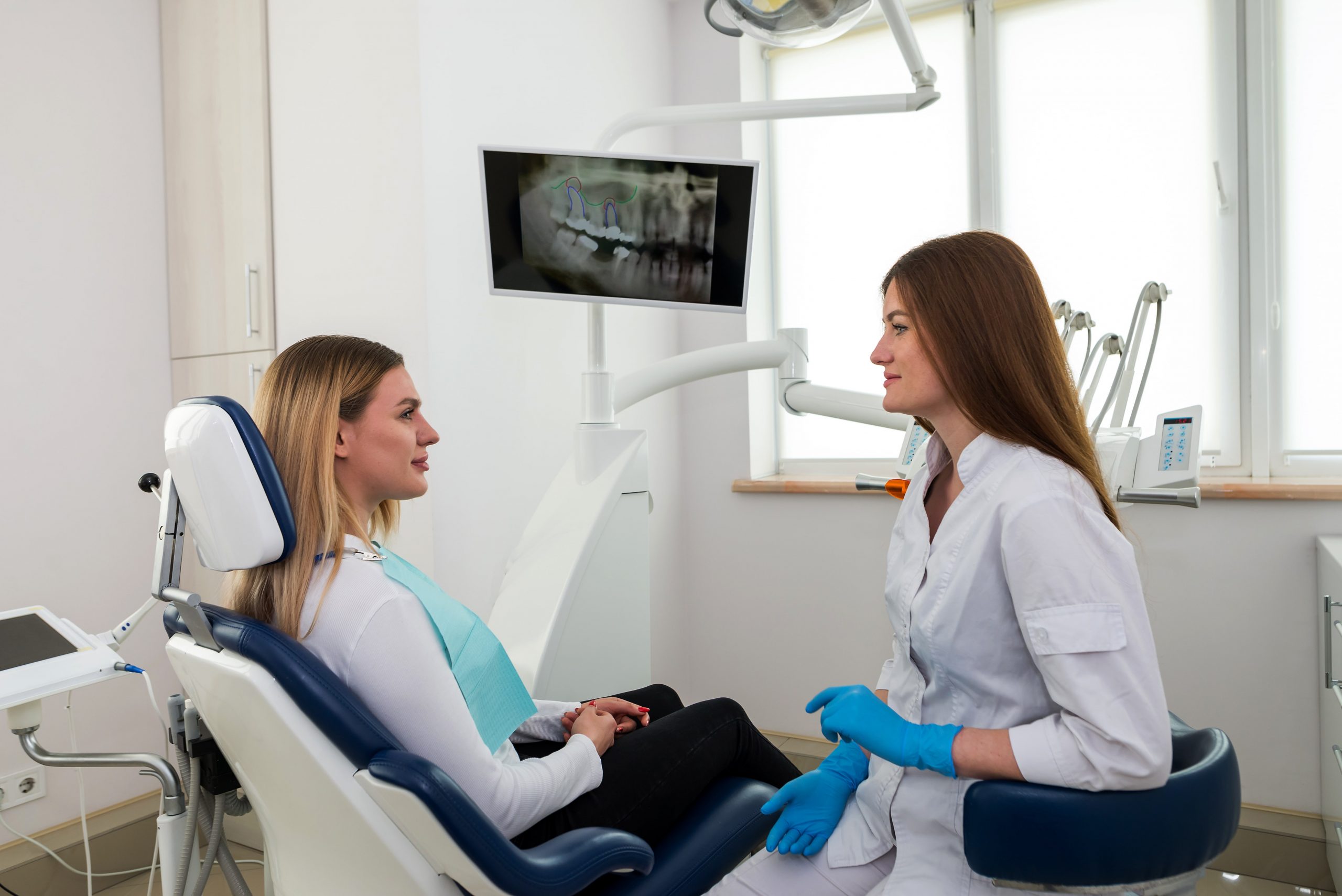 Dentist speaking to patient about treatment options.