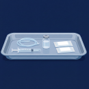 Illustration of a medical sedation tray on a dark blue background containing a syringe, clear tubing, a medication vial, and two sealed packets arranged neatly inside a plastic tray.
